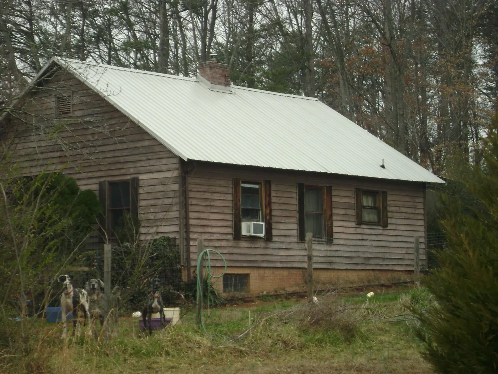 White metal roof on an old wood sided farmhouse, from a Metal Roof Installation job in Harford